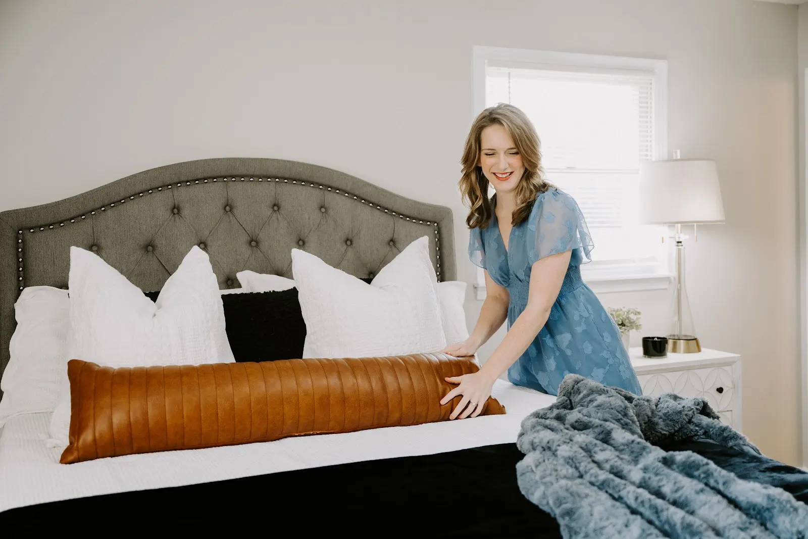 Rachel Ferrell preparing a bedroom for a home showing