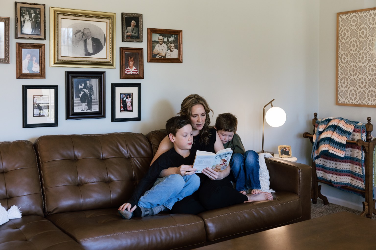 Rachel Ferrell reading Charlotte’s Web with her two sons on the living room couch
